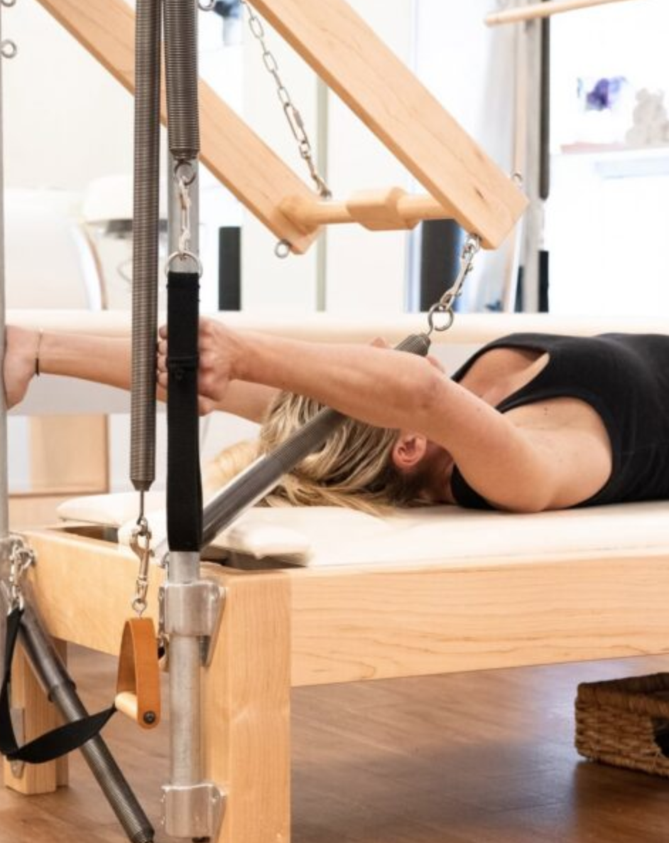 Client on the Cadillac during a Pilates session at Sharp Pilates™ in Austin, TX