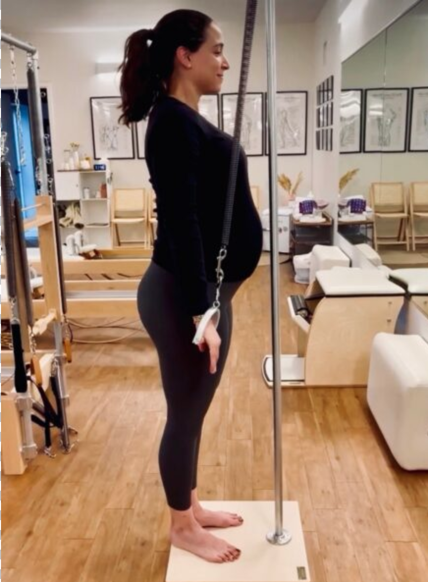 Pregnant client doing prenatal Pilates on the Cadillac at Sharp Pilates in Austin, TX