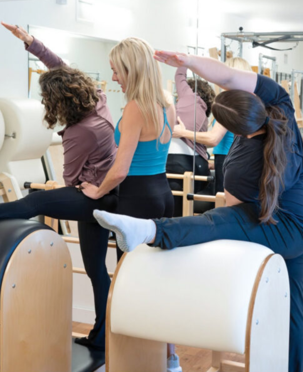 Clients stretching on Ladder Barrels for back pain relief at Sharp Pilates in Austin, TX