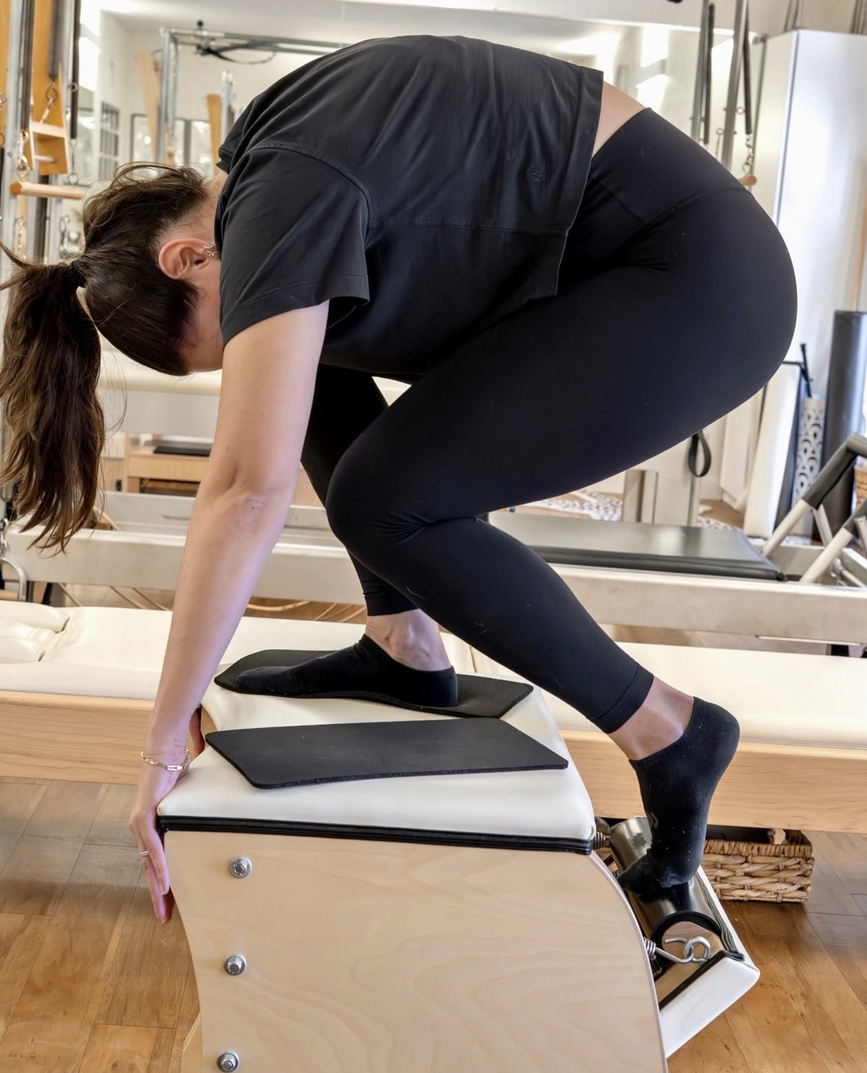 Client stretching on the ladder barrel at Sharp Pilates™ Austin